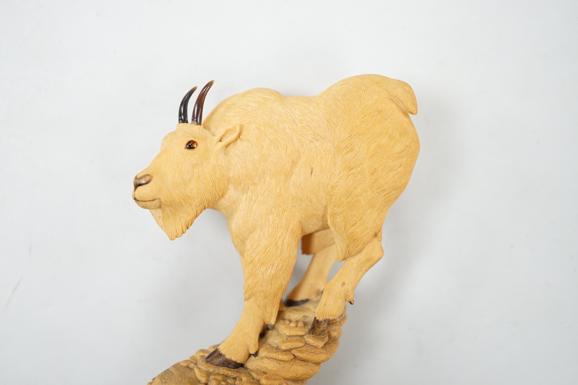 Nick Lamb, a fine cased boxwood okimono carving of a mountain ram, 9cm high